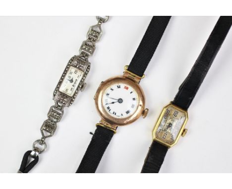 A 9ct gold cased ladies wristwatch with white enamel dial and black roman numerals, along with a further continental gold cas