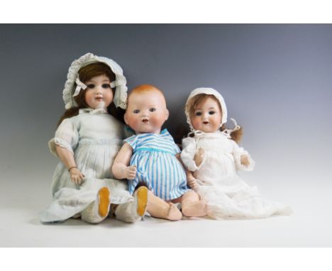 Three Armand Marseille bisque head dolls, early 20th century, the first stamped 'A.M Germany 351.14.K' with rolling blue glas