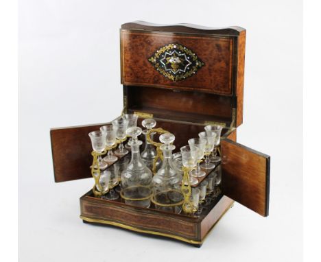 A late 19th/early 20th century amboyna, mother of pearl and brass inlaid liquor set, the decanter box of serpentine rectangul