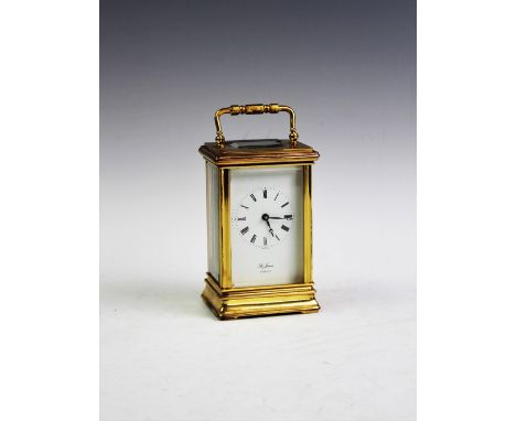 A presentation brass carriage timepiece by 'St James, London', mid 20th century, with Roman numeral white enamel dial, 13cm h