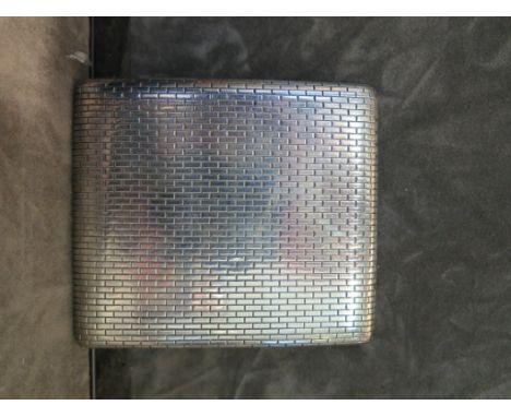 A silver cigarette case having engine turned decoration