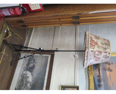 An Edwardian brass fire fender, with leaf scroll corners and fender bar, 159cm wide, together with a wrought iron standard la