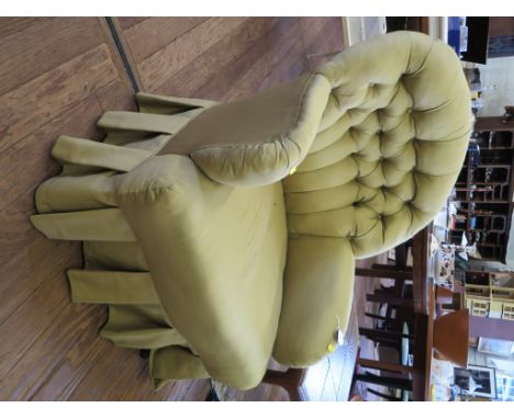 A button upholstered armchair, on square oak legs and castors, 1950s