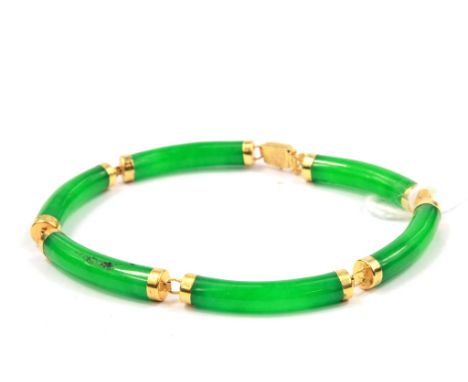 A jade bracelet set in 14 carat gold