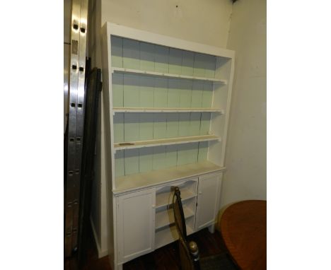 A pale turquoise and cream painted kitchen dresser, having a three shelf panelled back above two cupboard doors H.195cm W.120