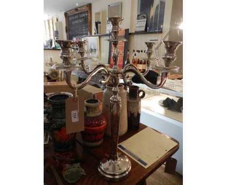 A silver plated four branch five light candelabra with stepped circular base. H.62cm