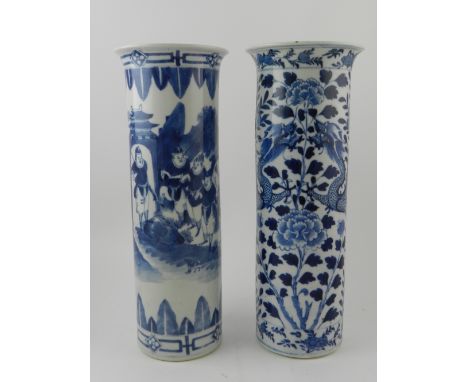 A near pair of Chinese blue and white cylindrical porcelain vases, decorated with dragons, flowers and Chinese figures, each 