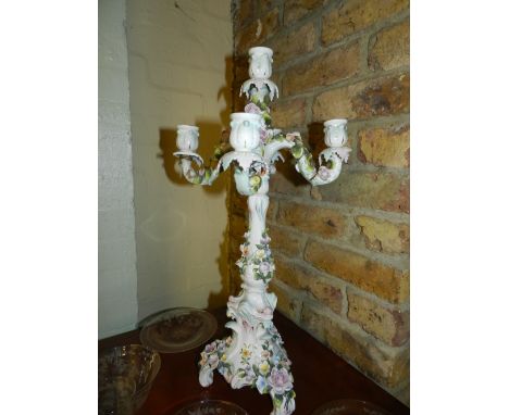 A pair of 20th century Dresden porcelain five light, four branch candelabrum in the Rococo style, encrusted with flowers, rai