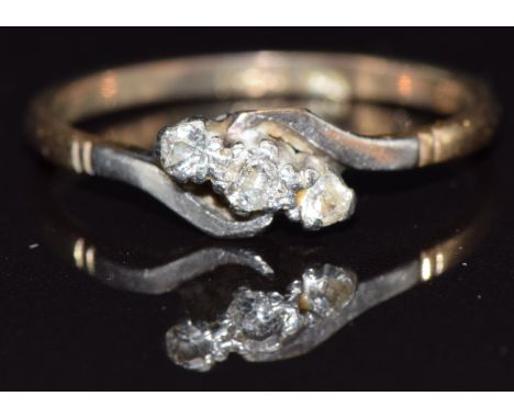 A 9ct gold ring set with three diamonds in a platinum twist setting, size R, 2.3g