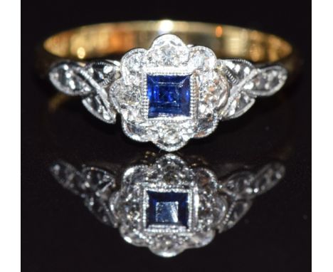 An 18ct gold ring set with a sapphire and diamonds in a platinum setting, size M, 2.3g