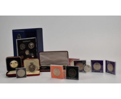 A collection of various cupronickel cased crown sized coins, a first decimal set and a Bahrain set