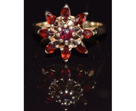 A 9ct gold ring set with garnets in a cluster, size J, 2.7g