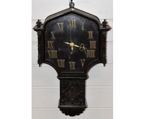 Oak cased c1920 carved drop dial wall clock with Roman brass numerals and three train movement striking on a gong