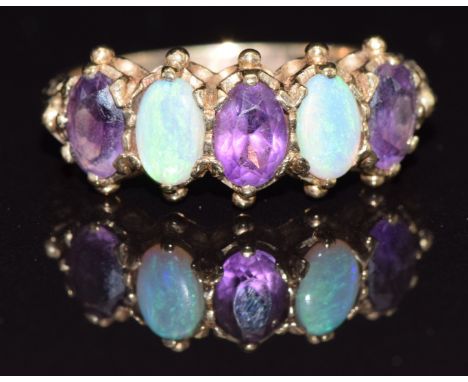 A 9ct gold ring set with opals and amethyst, size P, 3.2g