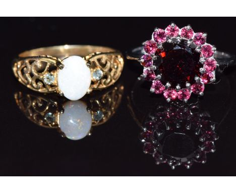 A 9ct white gold ring set with garnets and a 9ct gold ring set with an opal and alexandrite, size N, 5.6g