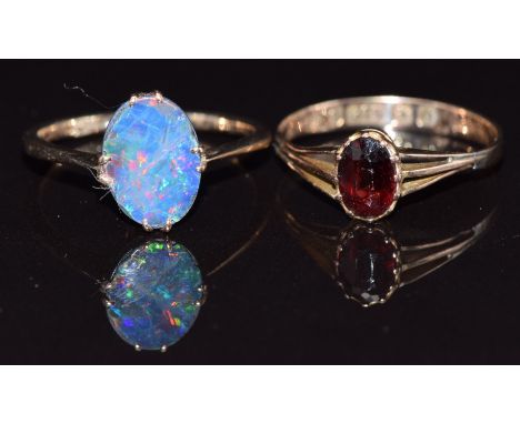 Two 9ct gold rings, one set with an opal doublet the other a garnet, size M, 2.7g