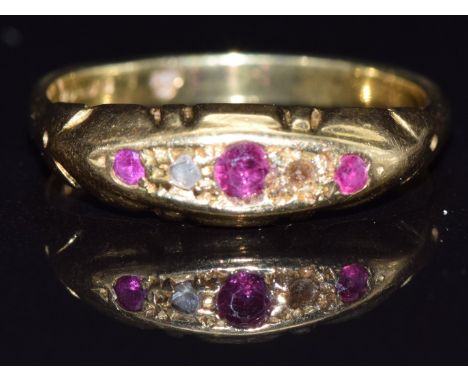 An 18ct gold ring set with rubies and a diamond, size K, 2.9g