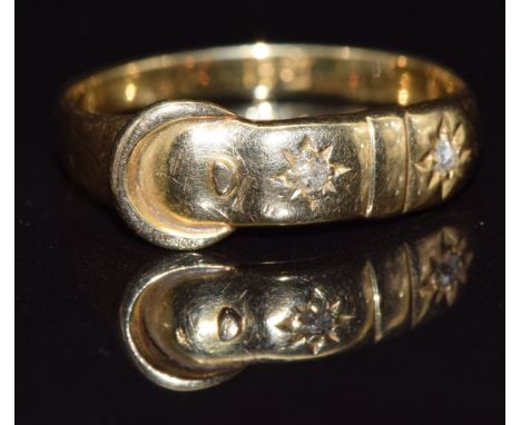 An 18ct gold buckle ring set with two diamonds,&nbsp;c1900, size O, 2.3g