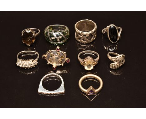 Ten silver rings set with diamonds, garnets amethyst, quartz, etc