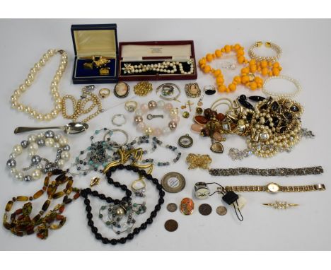 A collection of costume jewellery including beads, silver cross pendant, D &amp; G ring, compass charm, etc