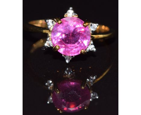 A 9ct gold ring set with a ruby surrounded by white sapphires, size M, 3.3g