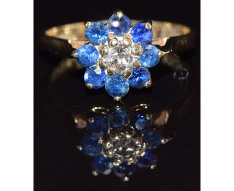 A 9ct gold ring set with a diamond surrounded by sapphires, size J, 2.1g