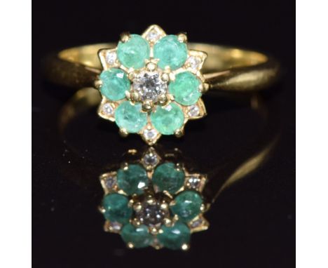 An 18ct gold ring set with a diamonds and emeralds, size M, 3.5g