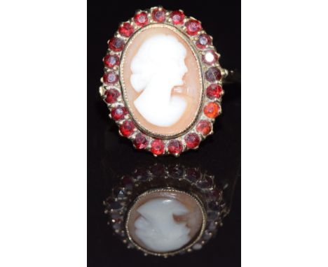 A 9ct gold ring set with a cameo surrounded by garnets, size L, 4.3g