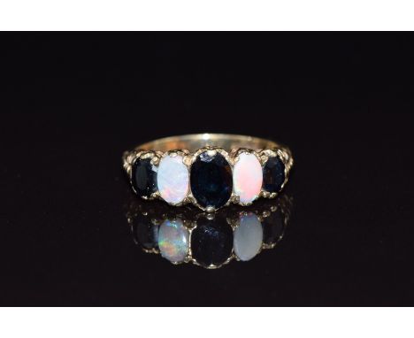 A 9ct gold ring set with oval cut sapphires and opal cabochons, size N, 3.6g