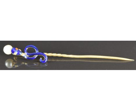 Victorian yellow metal stick pin in the form of a snake/ serpent set with blue enamel and holding a faux pearl, 1.9g