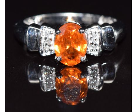 A 9k gold ring set with an oval cut garnet and diamond, size M, 3.3g