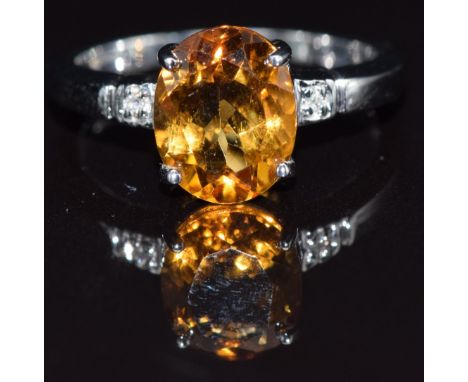 A 9k white gold ring set with an oval cut citrine and diamonds, size N, 3.3g