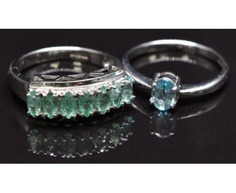 A 9ct white gold ring set with emeralds and a 9ct gold ring set with an aquamarine, size N, 5.5g&nbsp;