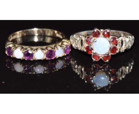 A 9ct gold half eternity ring set with opals and garnets and a silver ring set with an opal and garnets, size P