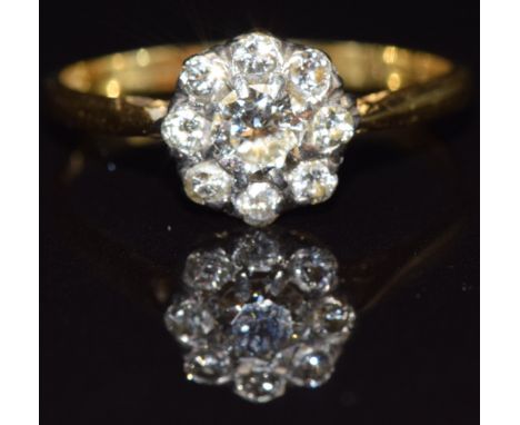 An 18ct gold diamond daisy cluster ring, the centre diamond aprroximately 0.3cts, size N, 2.2g