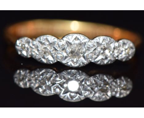 An 18ct gold ring set with five diamonds in a platinum setting, size L, 2.1g