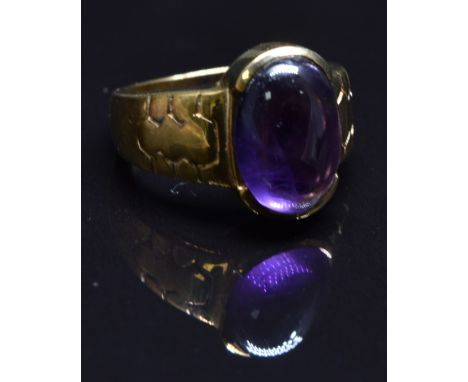 A 9ct gold ring set with an amethyst cabochon, size N, 8.3g