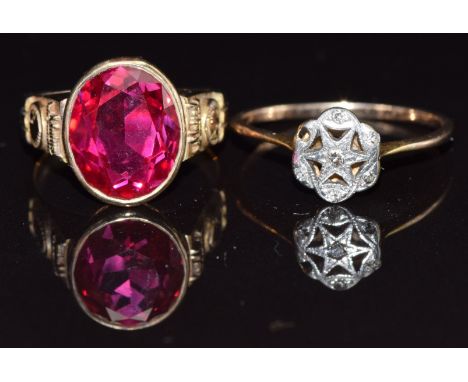 A yellow metal ring set with diamonds in a platinum star setting and a 10k gold ring set with a synthetic ruby, 6.4g&nbsp;