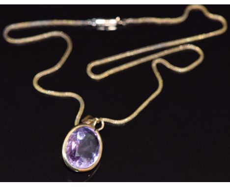 A 9ct gold necklace and 9ct gold pendant set with an oval cut amethyst measuring approximately 14.6cts, 7.8g