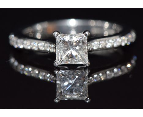 A platinum ring set with a princess cut diamond of approximately 0.7ct&nbsp;with further diamonds to the shoulders, in origin