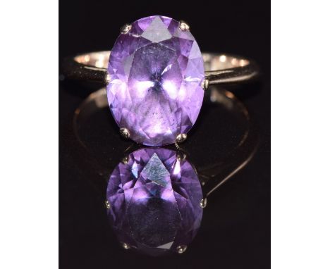 A 9ct gold ring set with a purple synthetic sapphire, size M, 3g