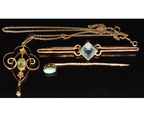 Edwardian 9ct gold pendant set with a peridot on 9ct gold chain, a 9ct gold stick pin set with a turquoise cabochon and a 9ct