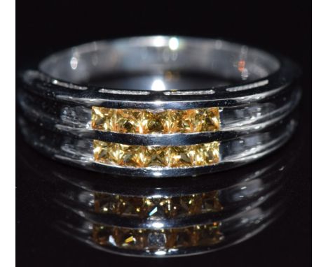 A 9k white gold ring set with yellow sapphires, size M/N, 3.5g