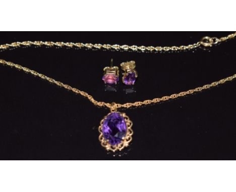 A 9ct gold necklace set with an oval cut amethyst and a pair of 9ct gold earrings set with an amethyst to each, 7g