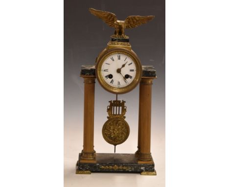 French Empire Portico clock mounted on reeded brass Roman columns and marble base, surmounted by an eagle, the movement stamp