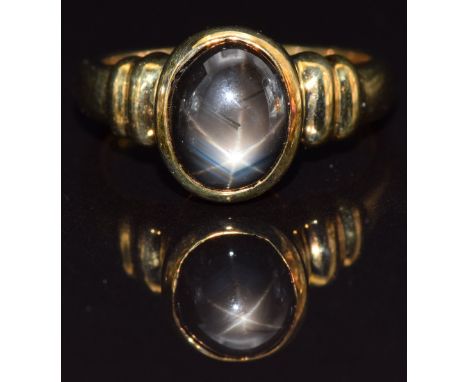 A 9k gold ring set with a synthetic black star sapphire, size N, 5g