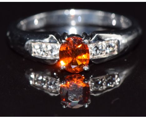 A 9k gold ring set with clinohumite and topaz, size N, 3.3g