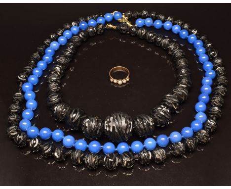 Two carved jet beaded necklaces, a glass beaded necklace and a yellow metal pearl ring&nbsp;