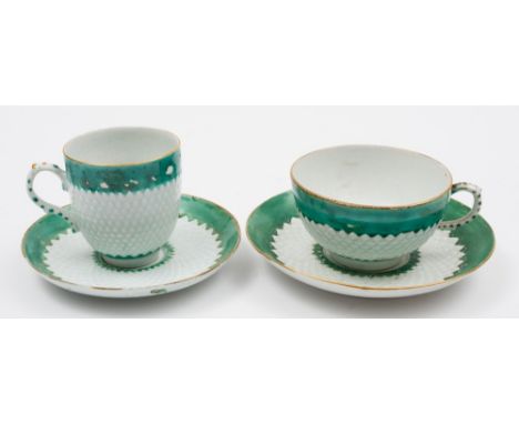 A Bow coffee cup and saucer and a similar teacup and saucer: with pinecone moulded and green enamel bands, the centres with g