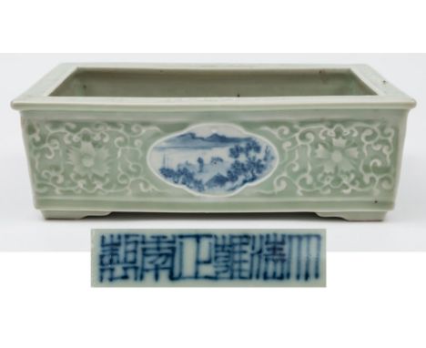 A Chinese porcelain celadon ground jardiniere: of shallow rectangular form with quadrilobed landscape panels painted in blue 